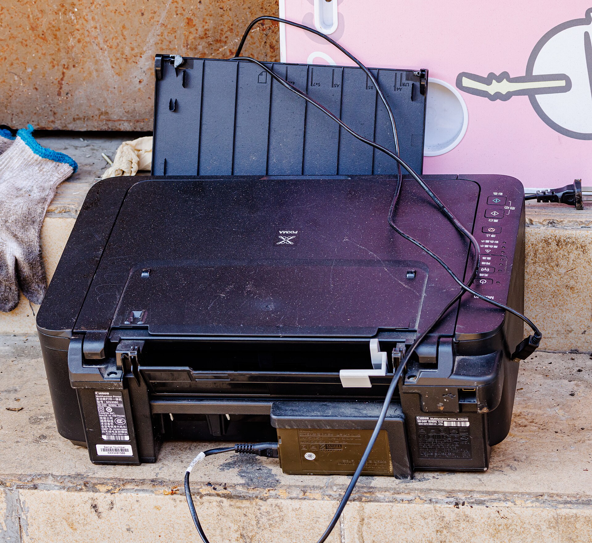 Discarded budget inkjet printer dumped outside with its cables tangled - where the £39 machines end up