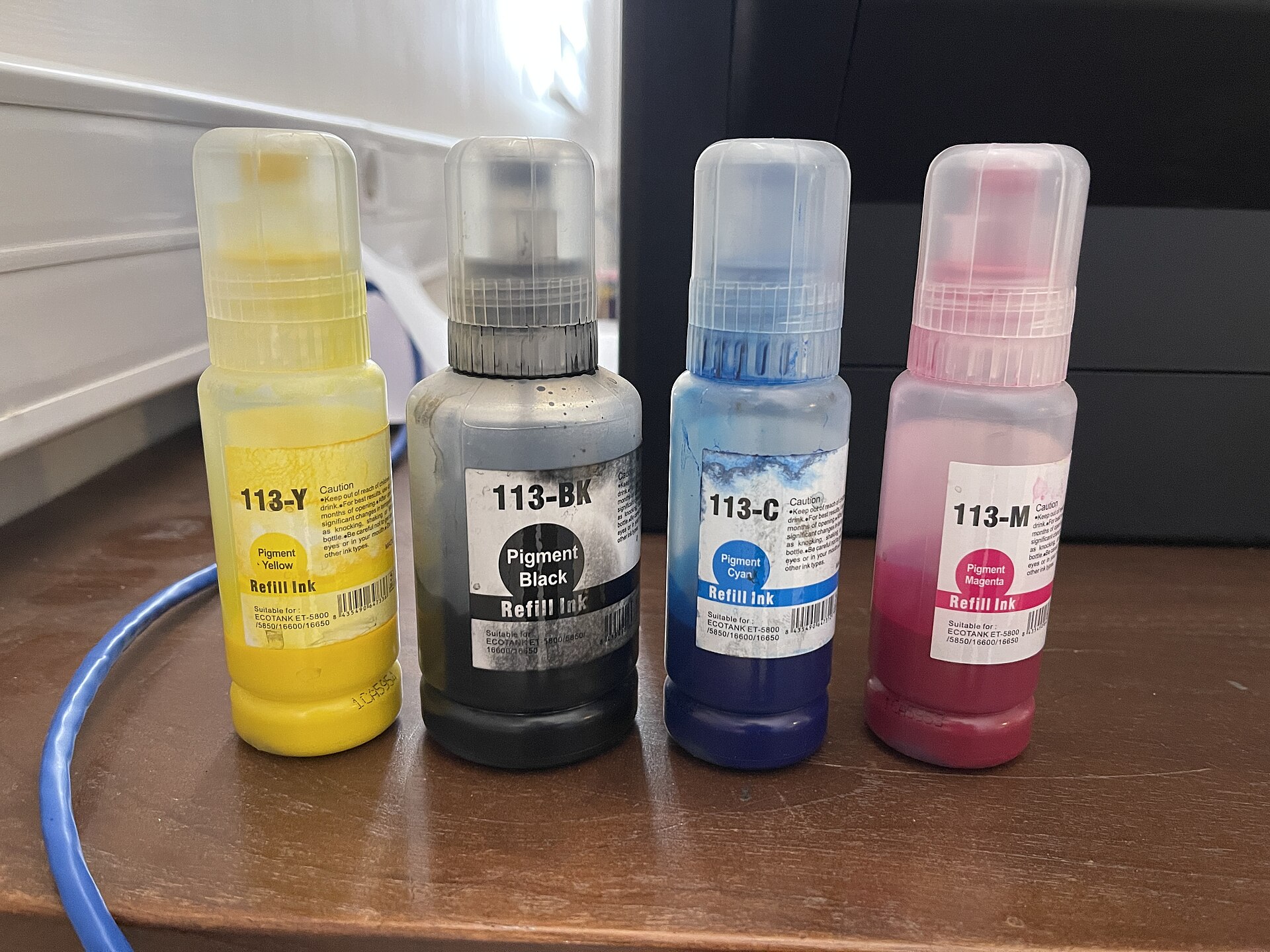 Epson EcoTank 113 refill ink bottles in black, cyan, magenta and yellow
