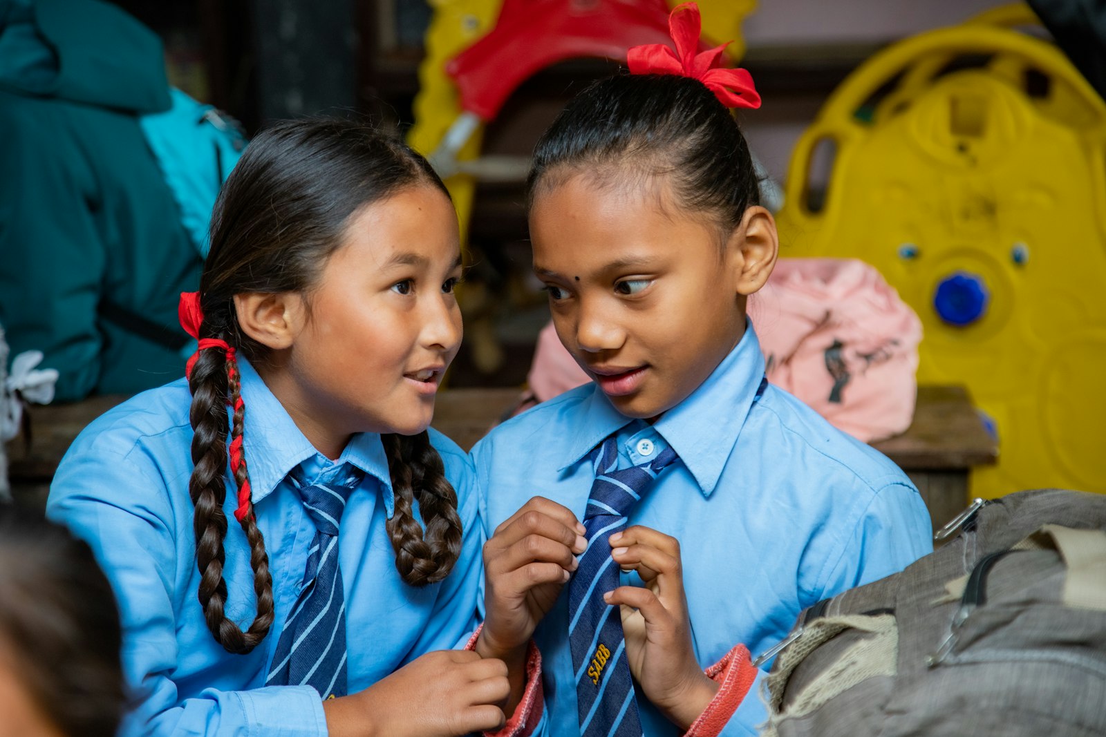 Secondary school pupils in uniform talking between lessons