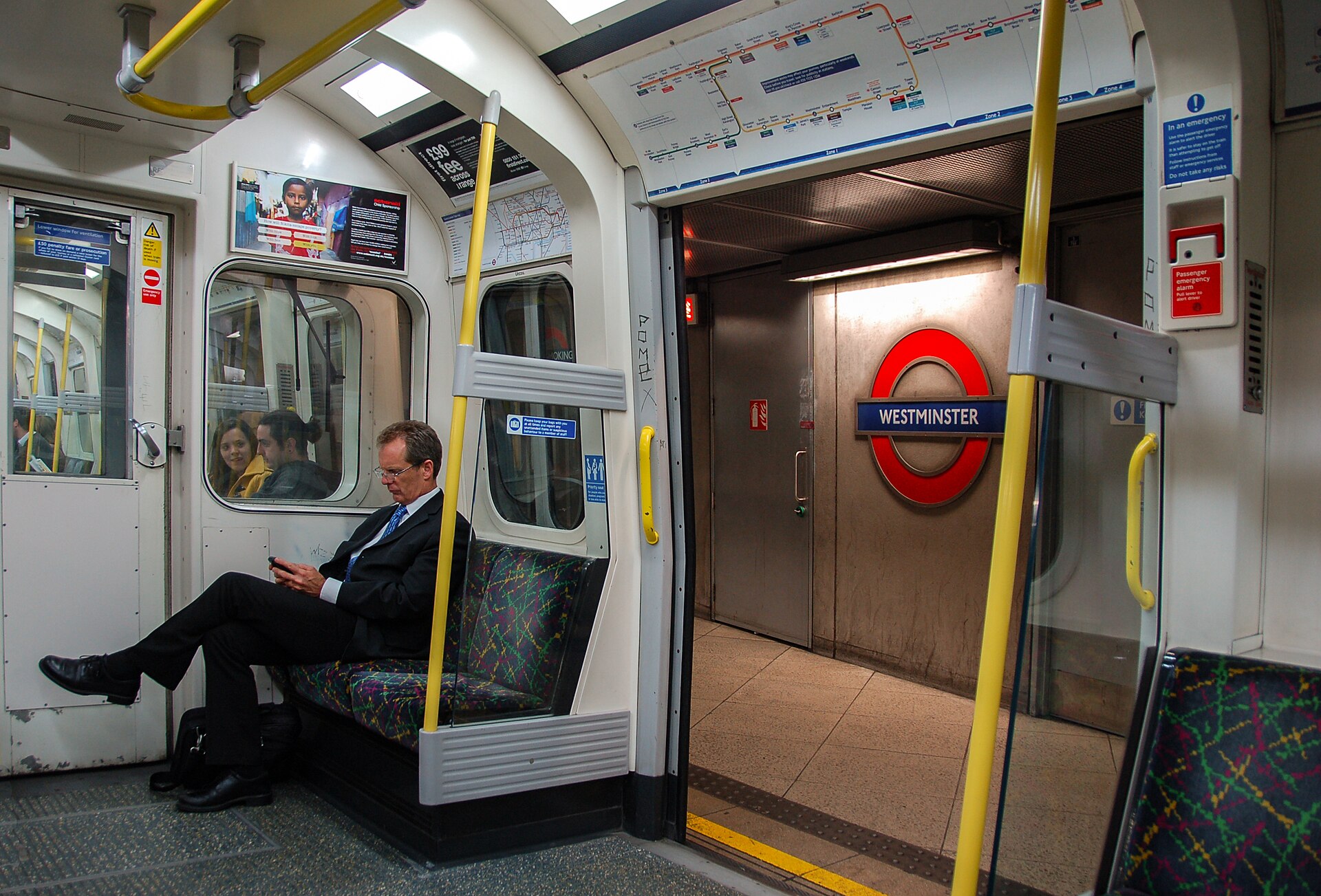 Commuter on a London Underground Circle line train at Westminster