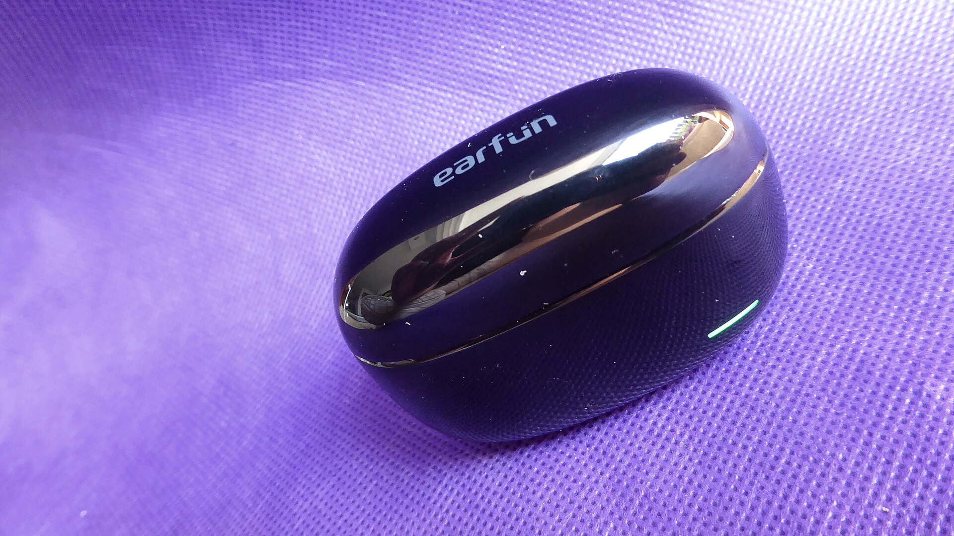 Black EarFun wireless earbud charging case in close-up
