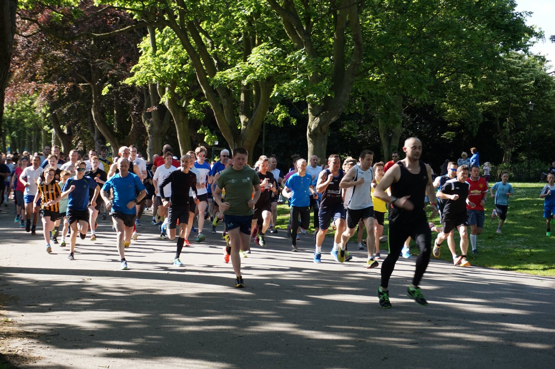 Runners setting off through a tree-lined UK park - the trials behind bovine colostrum benefits were all done on people in regular training