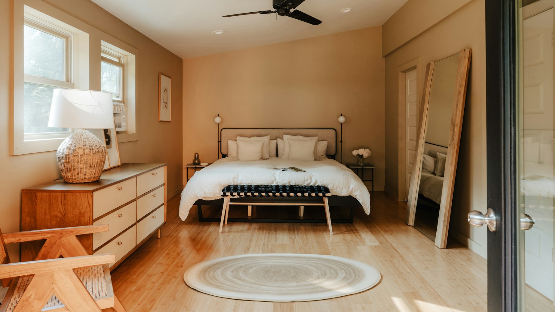 Bedroom with bare wood flooring, the stripped-back look of the floorboard decade that British homes are now reversing
