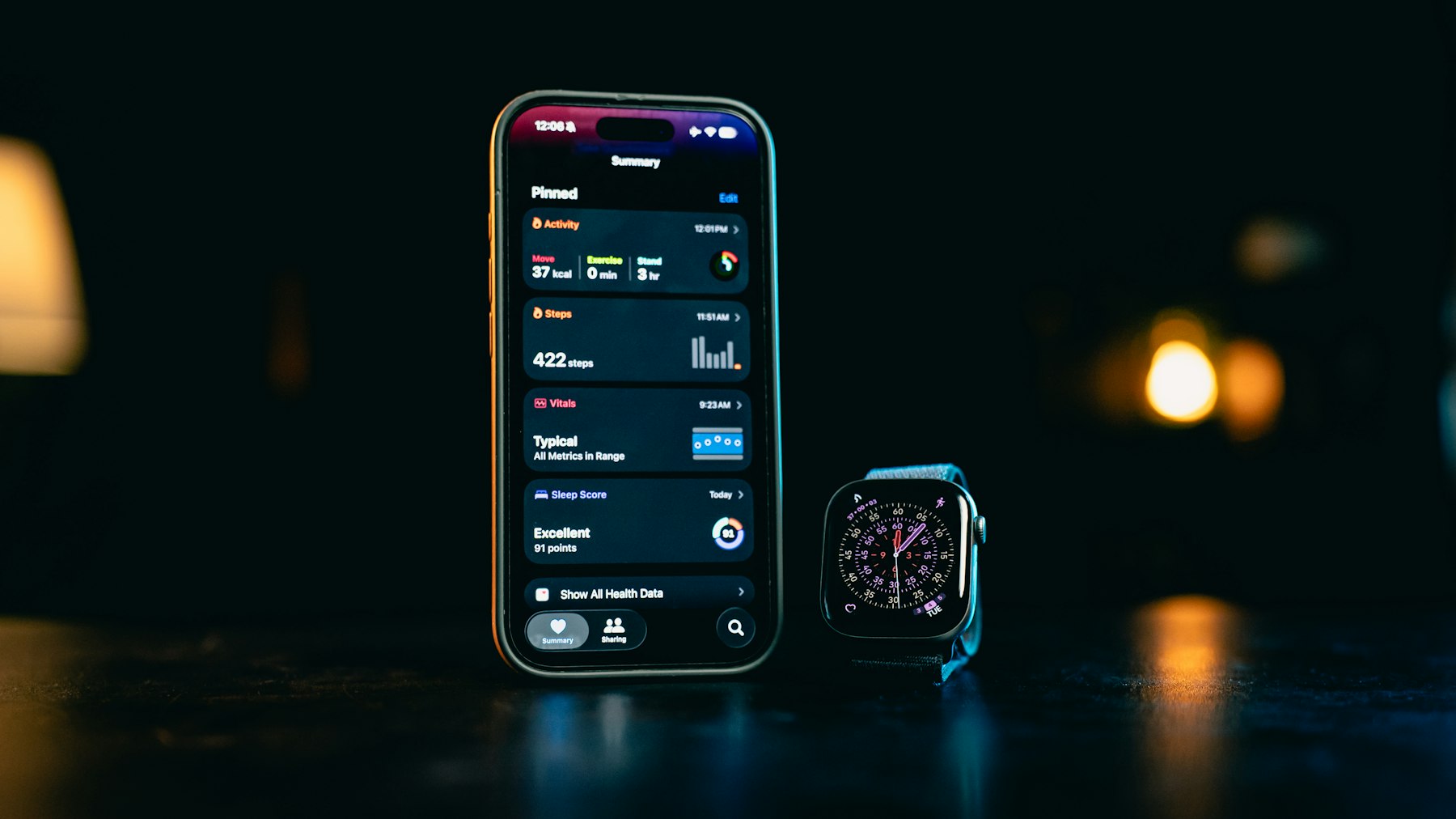 A smartphone and smartwatch displaying health tracking data