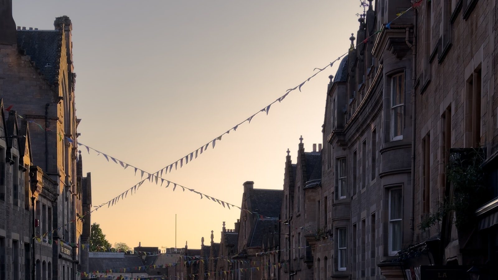 Bunting strung across Edinburgh's Old Town at dusk during the Fringe, the setting for the Edinburgh Comedy Awards 2026 shortlist