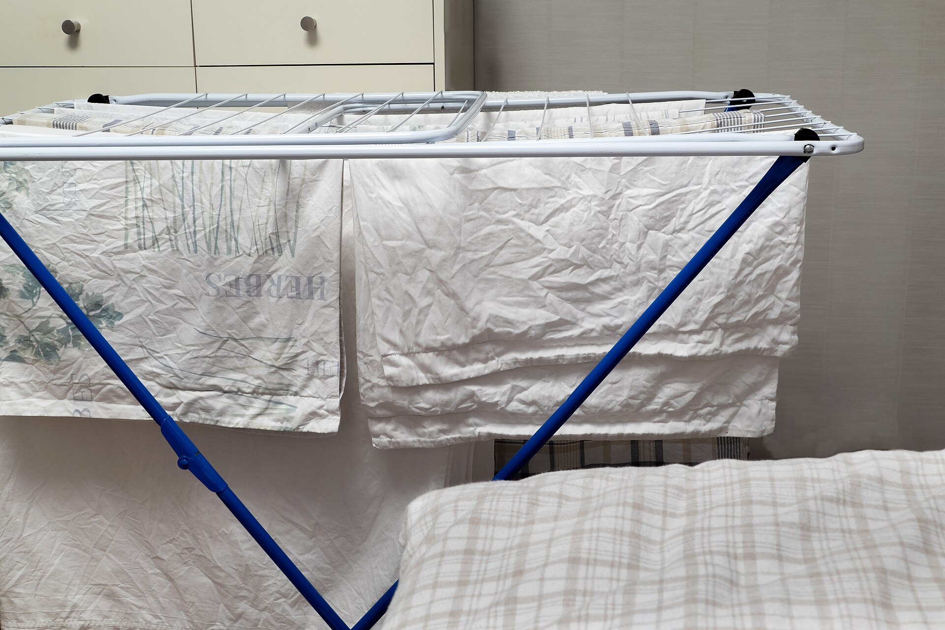 White laundry hanging on an indoor drying rack