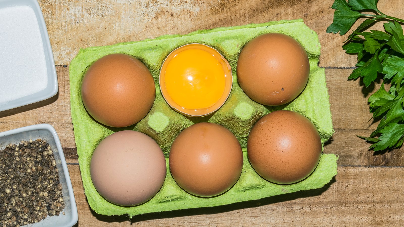 Open cartons of eggs stacked together - one of the cheapest protein sources in a British supermarket