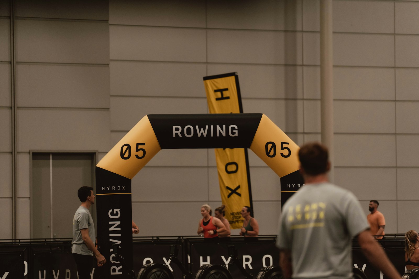 Inflatable rowing arch at a packed indoor Hyrox event
