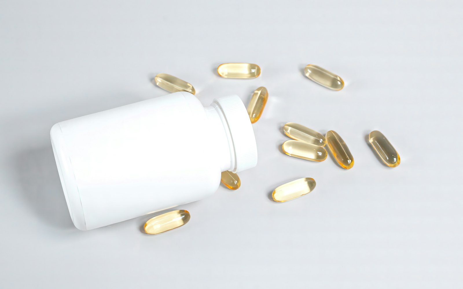 Supplement capsules spilling from a bottle - if you're weighing up whether shilajit is safe, a batch-tested capsule beats raw resin