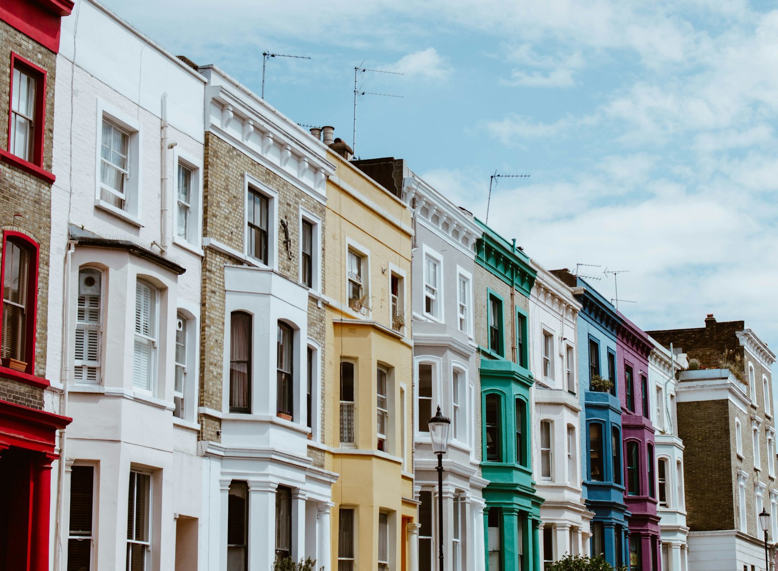 Row of British terraced houses in full afternoon sun - the homes that struggle most to keep cool in a heatwave