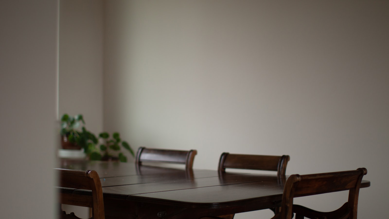 Secondhand wooden dining table with mismatched character in a home kitchen