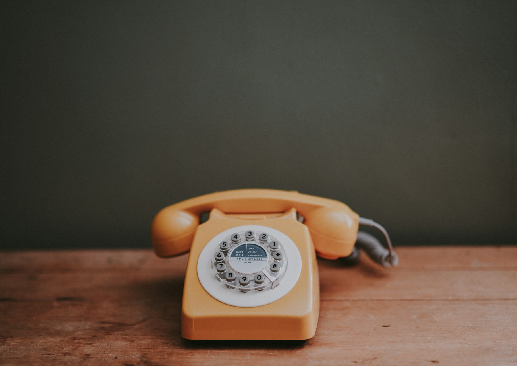 A rotary dial telephone in a grey painted room - millions of lines like this go silent in the landline switch off in January 2027