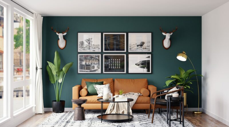 Brass floor lamp glowing against a dark green living room wall with a tan leather sofa