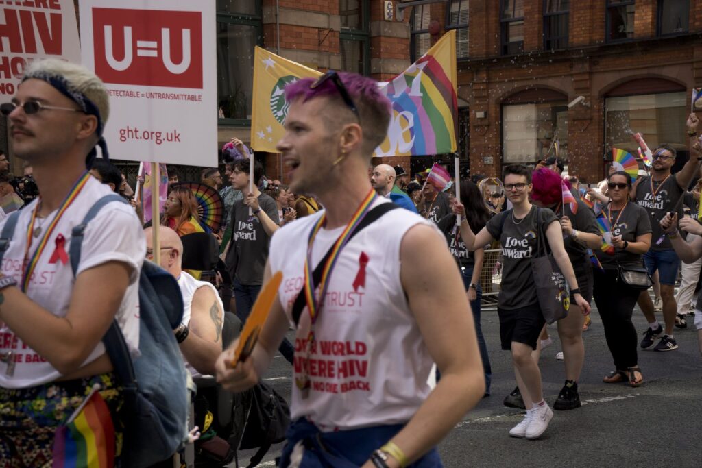 Manchester Pride 2026 - marchers with George House Trust placards in the Pride parade