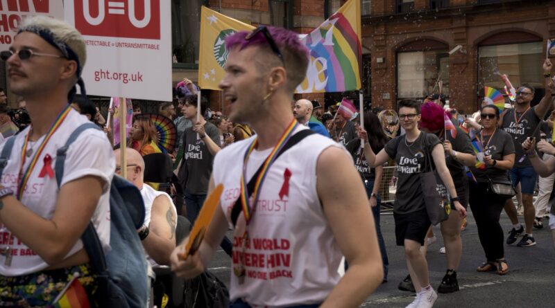 Manchester Pride 2026 - marchers with George House Trust placards in the Pride parade