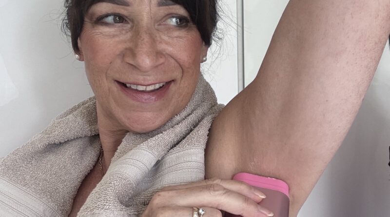 woman applying Wild deodorant