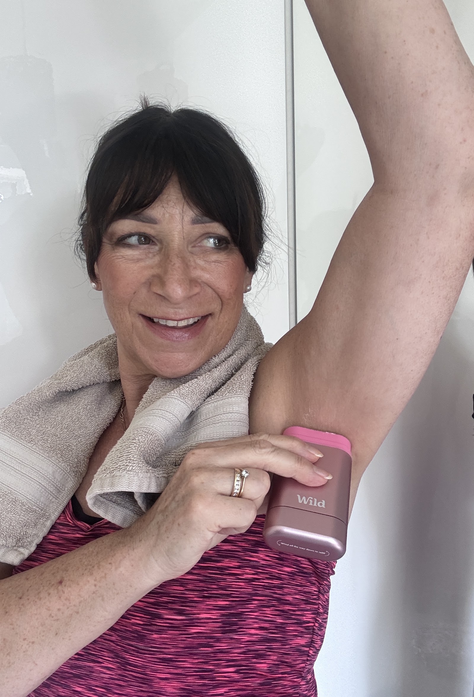 woman applying Wild deodorant