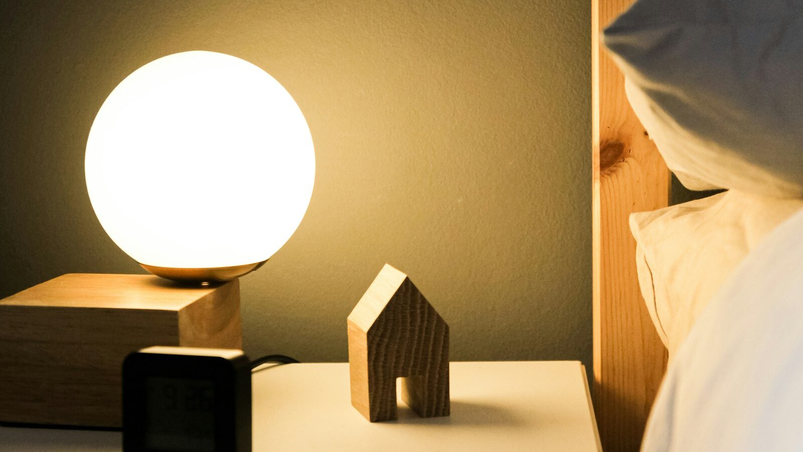 Bedside clock in a dark room, marking the 3am waking that mouth taping for sleep is often used to fix