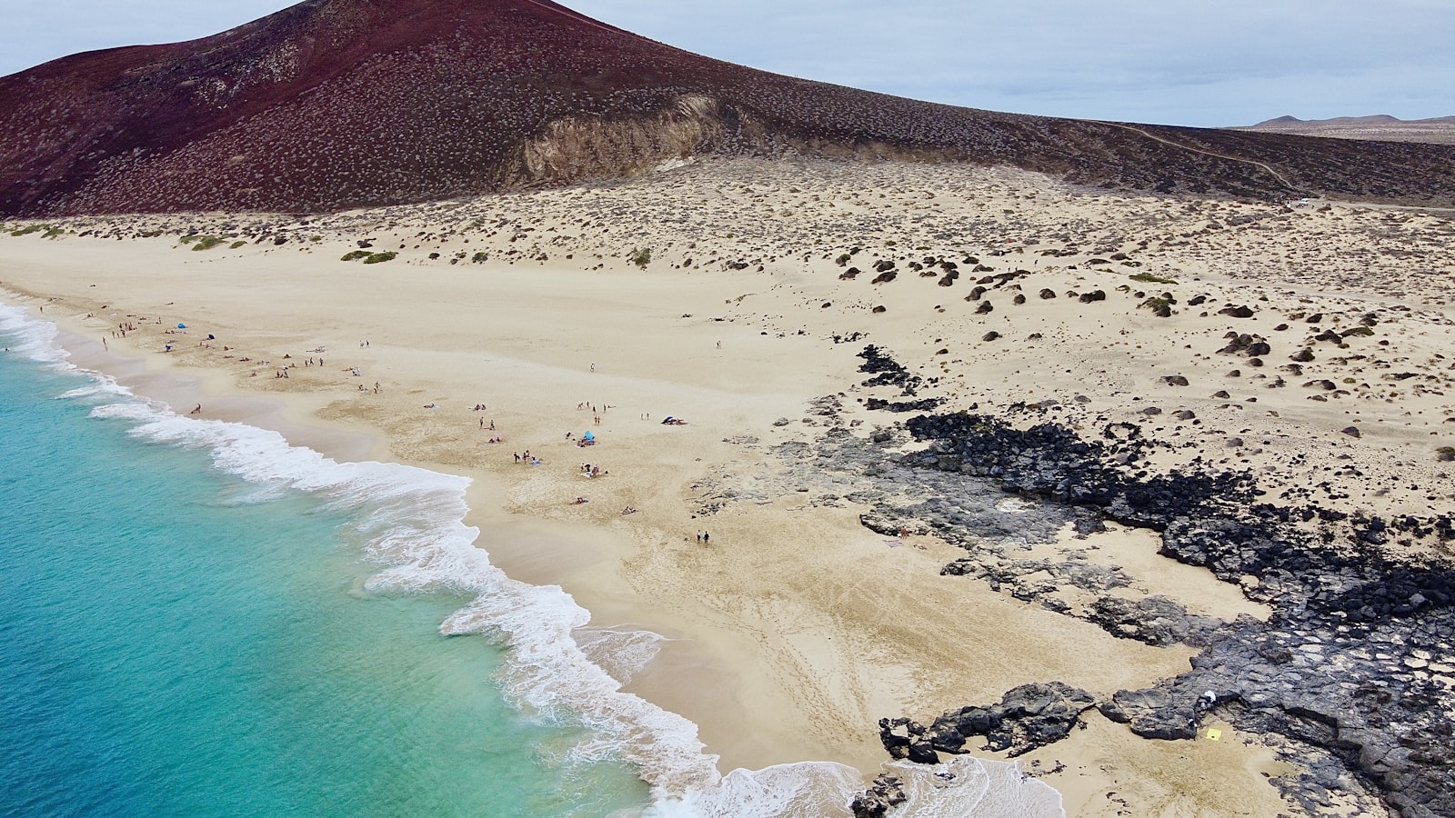 Volcanic coastline and warm sea in the Canary Islands, still summer weather in late October