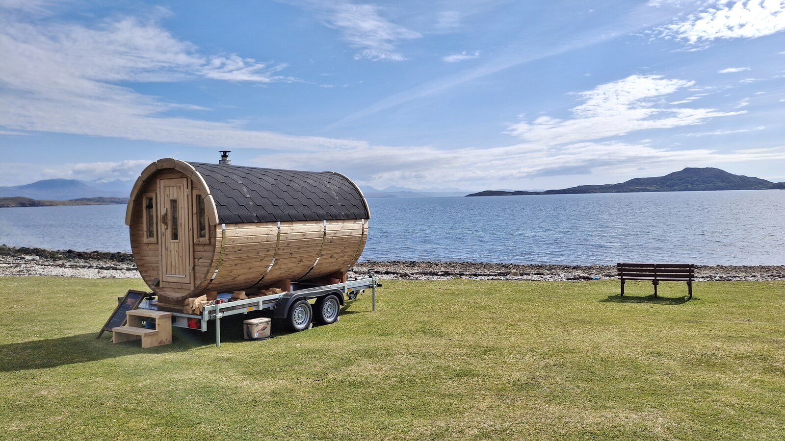 A wood-fired beach sauna on the shore at Badentarbat Bay in Scotland