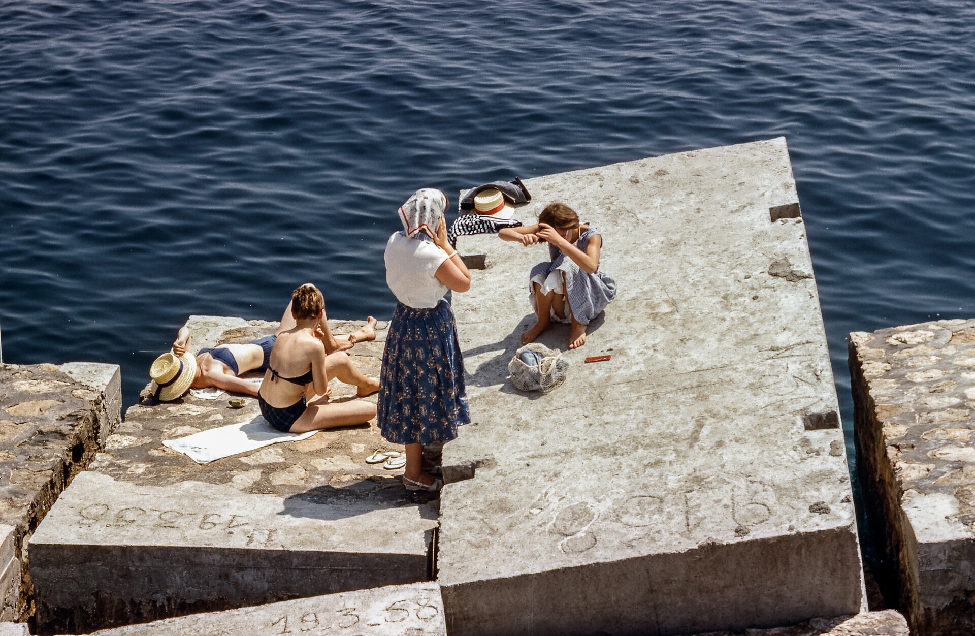 Sunbathers on a beach, the kind of UV exposure behind most skin cancer signs that appear later in the year
