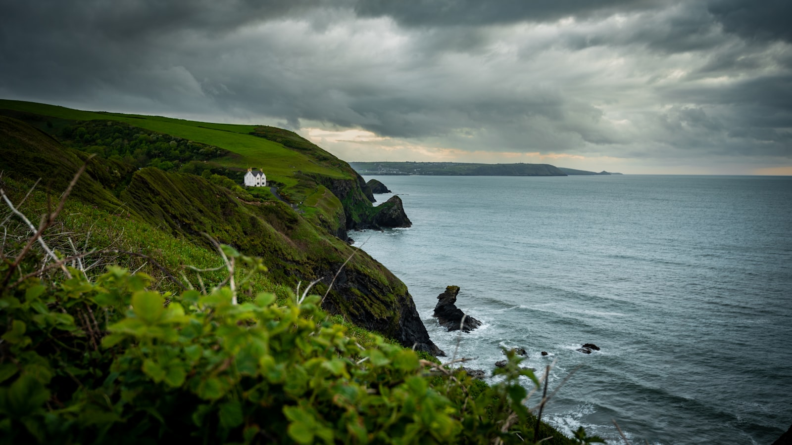 Moody clouds over a rugged coastline, standing in for the Welsh locations where the series was filmed