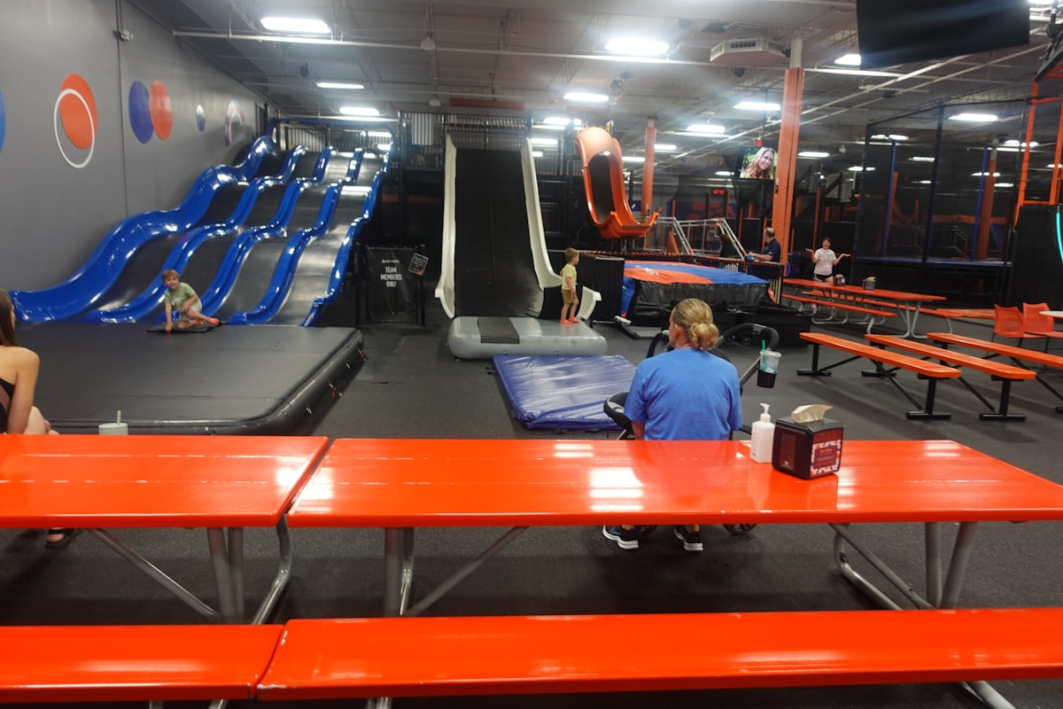 Activity stations and trampolines inside a UK trampoline park