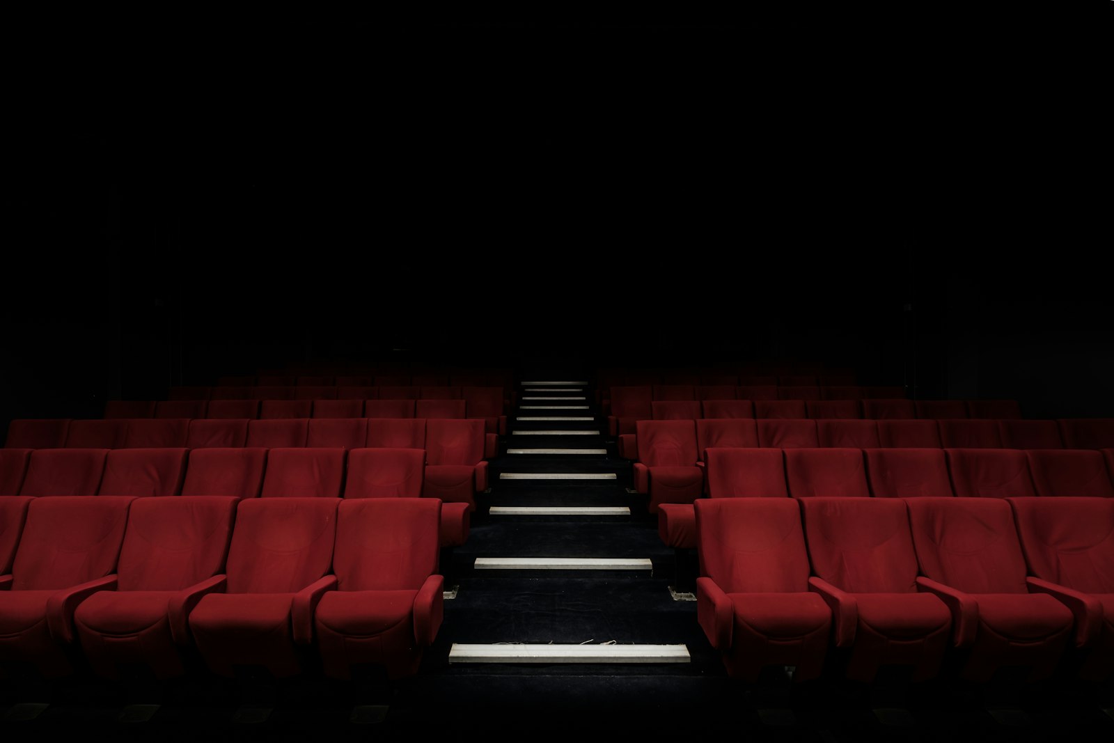 Rows of red cinema seats in a darkened auditorium - the UK box office 2026 recovery has been filling more of them than any year since the pandemic