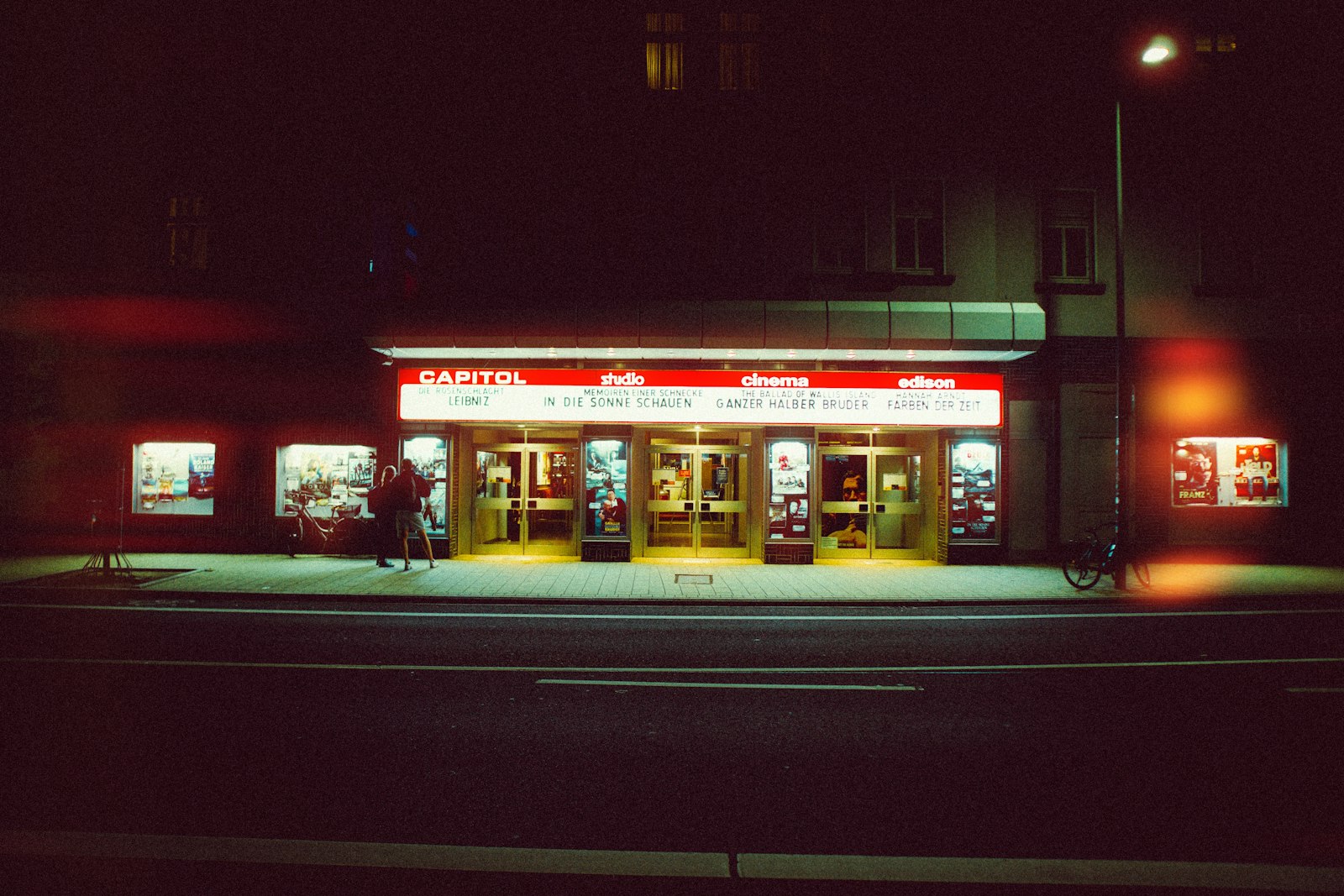 A brightly lit cinema entrance at night - the night out, not the film alone, is what cinemas are selling in 2026