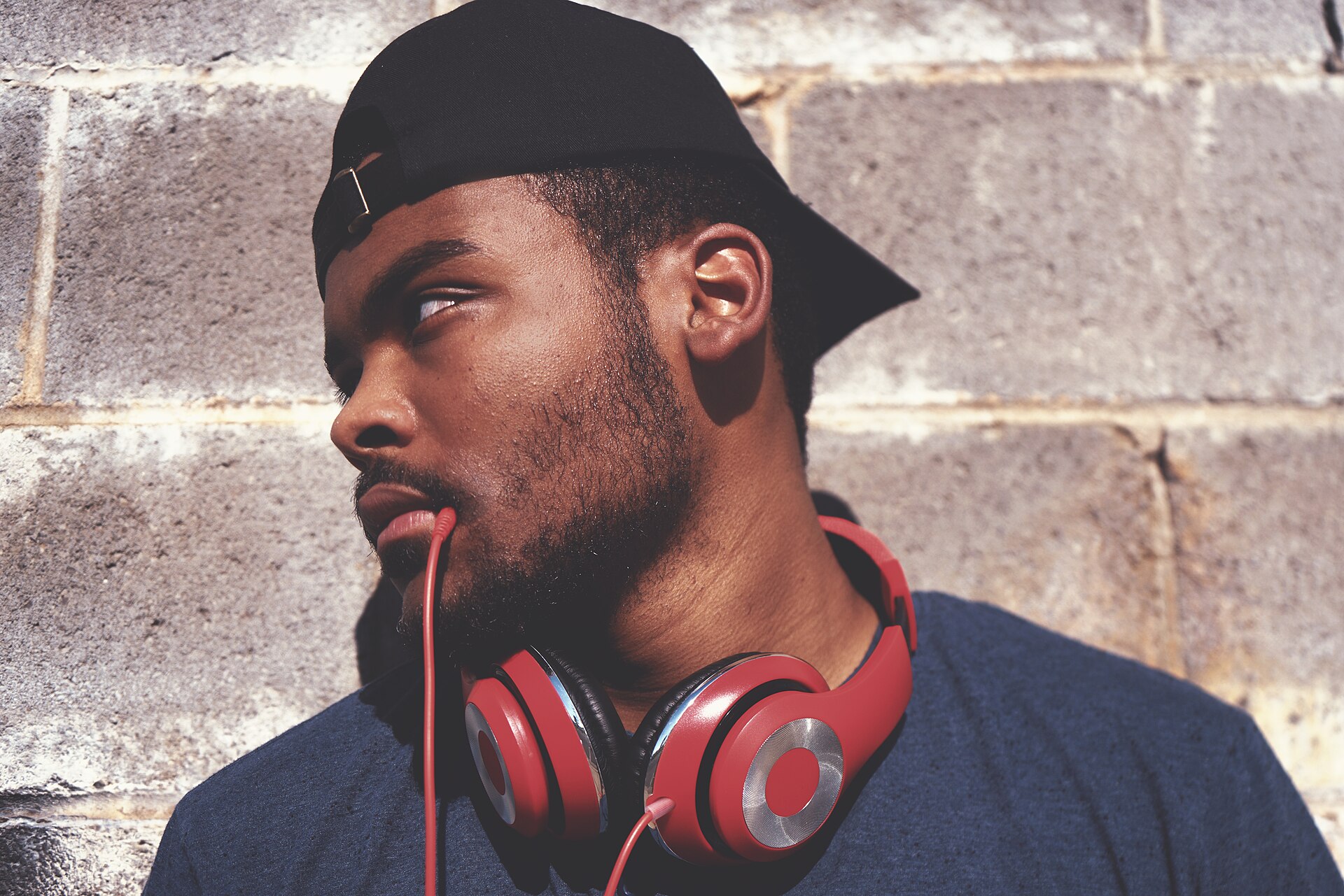 A man with headphones round his neck, the way most video podcasts UK audiences follow are actually consumed