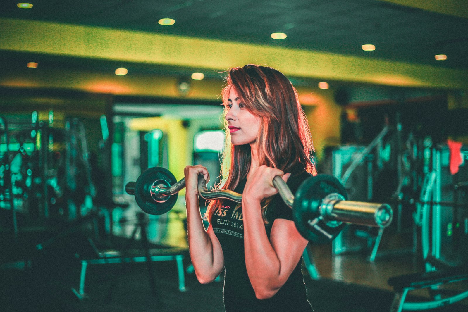 Woman lifting a barbell in a gym - resistance training remains the evidence-backed route to stronger bones