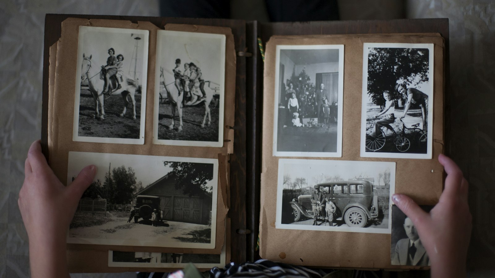 Hands turning the pages of an old photo album of black and white pictures, the kind of archive our 70 Up review argues is the whole point of the film
