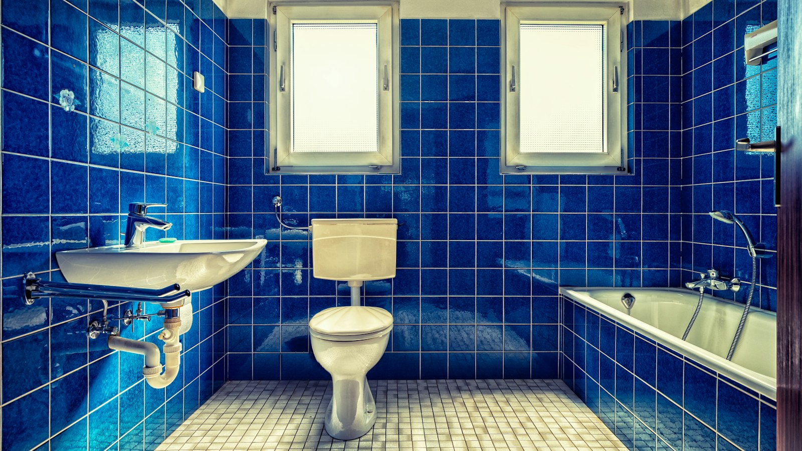 A retro blue-tiled bathroom - colour is coming back to British bathrooms in 2026