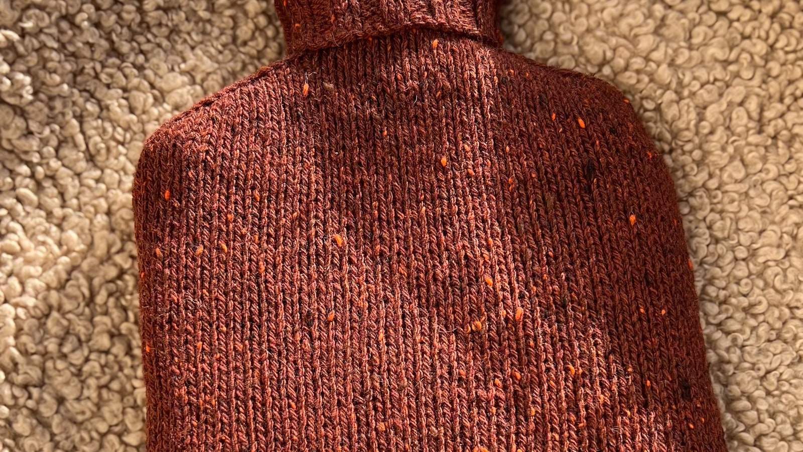Knitted hot water bottle cover, which Which? found matters more than the bottle for holding heat
