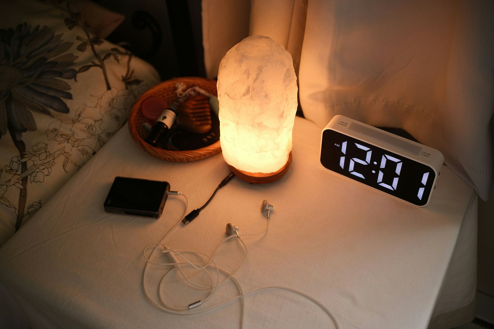 Bedside table with a lamp and clock - sunrise alarms are not therapy lamps