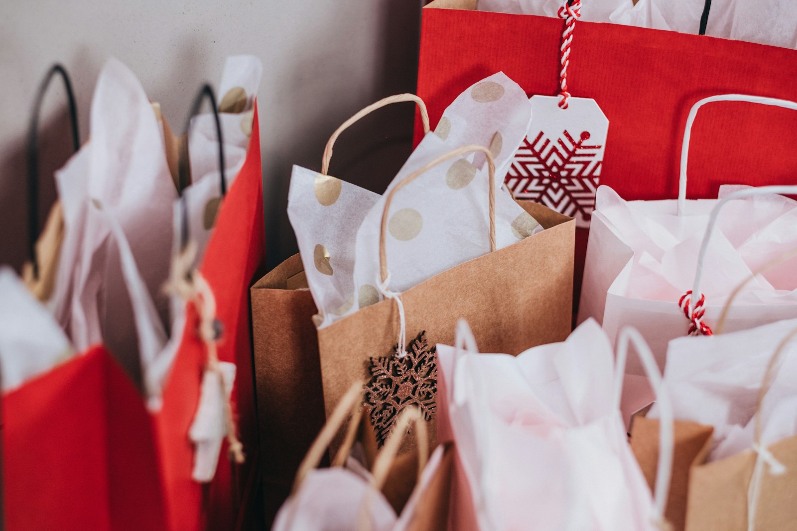 Stacked paper shopping bags representing Black Friday 2026 tech deals and pre-Christmas spending