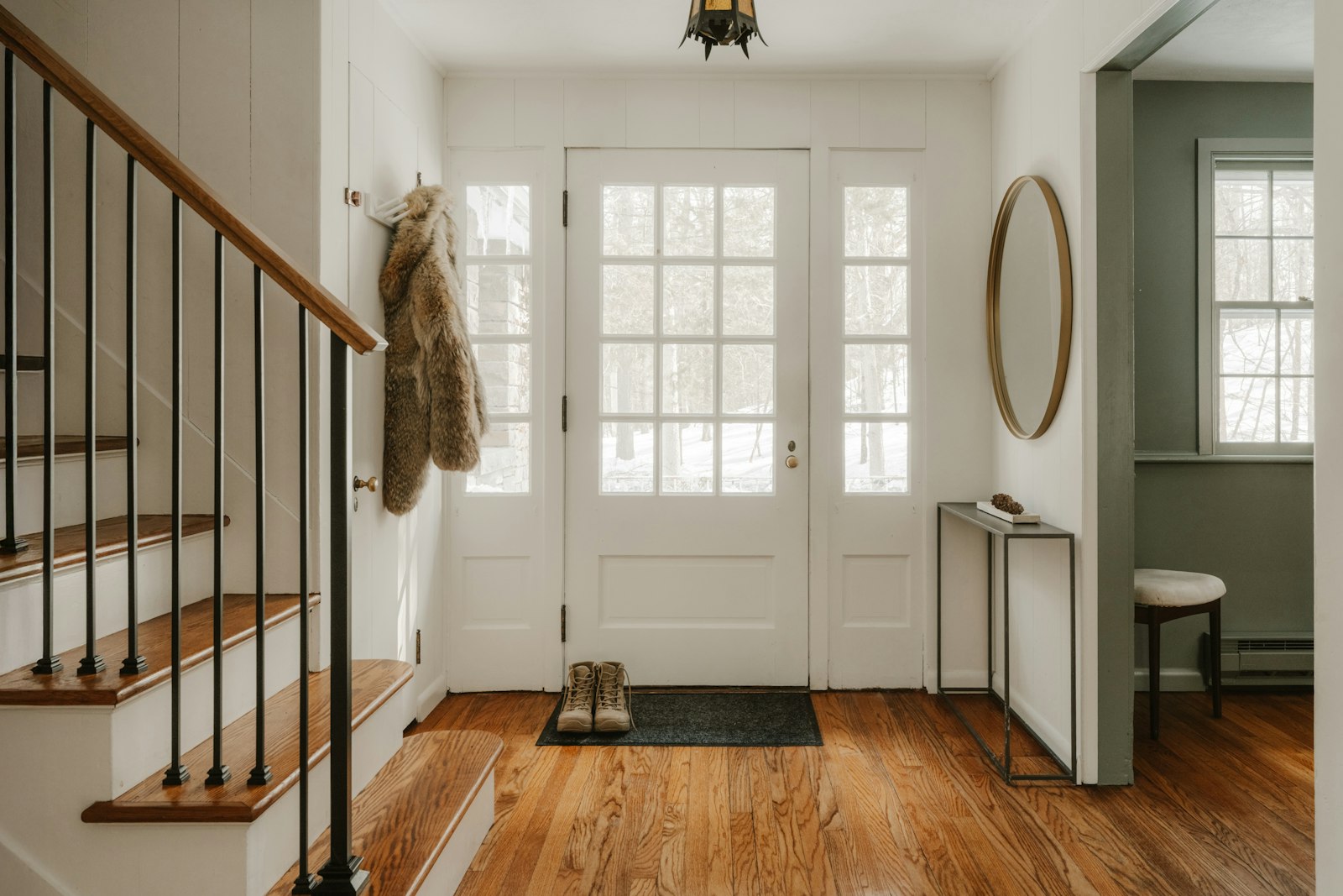A hallway entrance with wooden stairs - the space most British boot room ideas have to work with