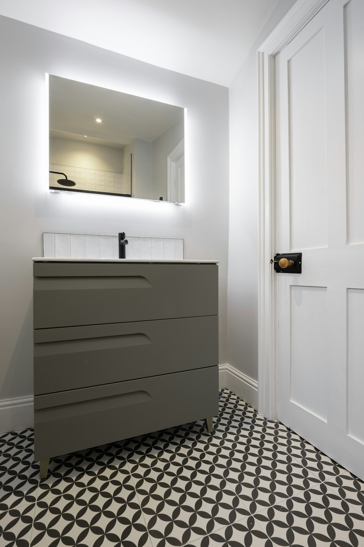 Black and white checkerboard floor tiles in a small bathroom