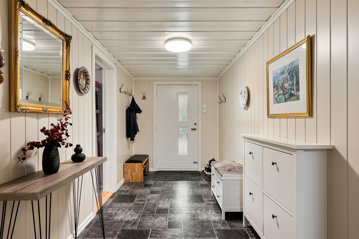 Long hallway with a black and white checkerboard floor laid straight