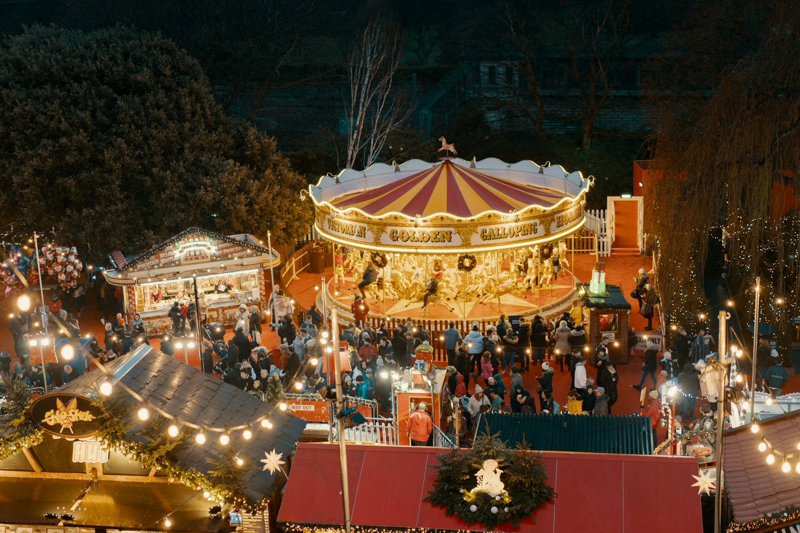 Lit carousel and market stalls at Edinburgh's Christmas market at night