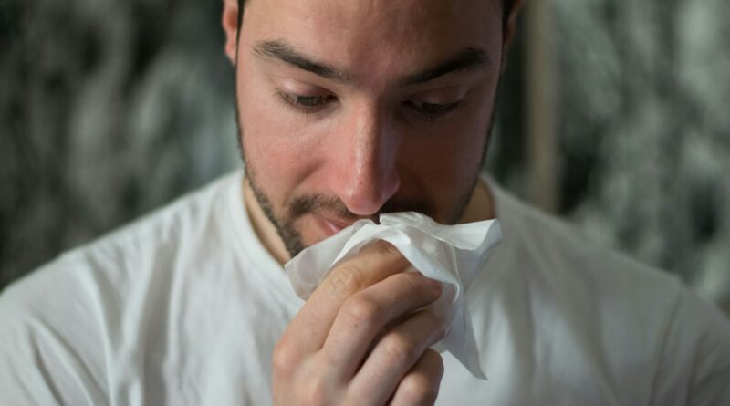 A man blowing his nose into a tissue - the start of Britain's cold and flu season and the search for cold and flu remedies that actually work