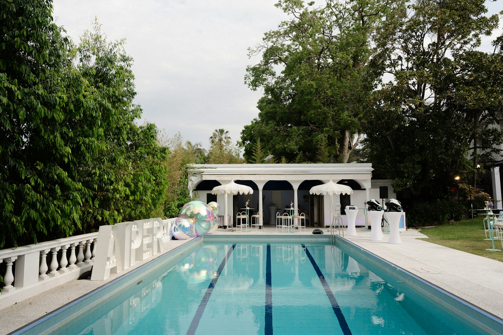 Outdoor lido pool surrounded by trees - a safer place to practise Float to Live than the open sea