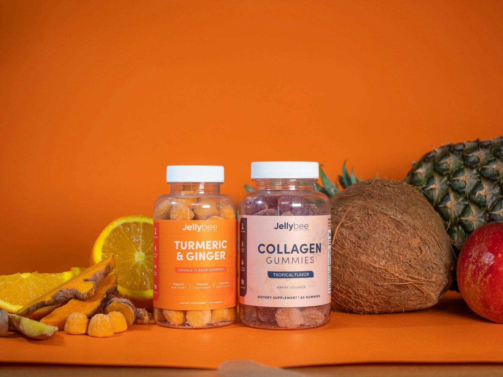 Two jars of collagen and turmeric gummies next to fruit - many gummies deliver under 1g of collagen a day
