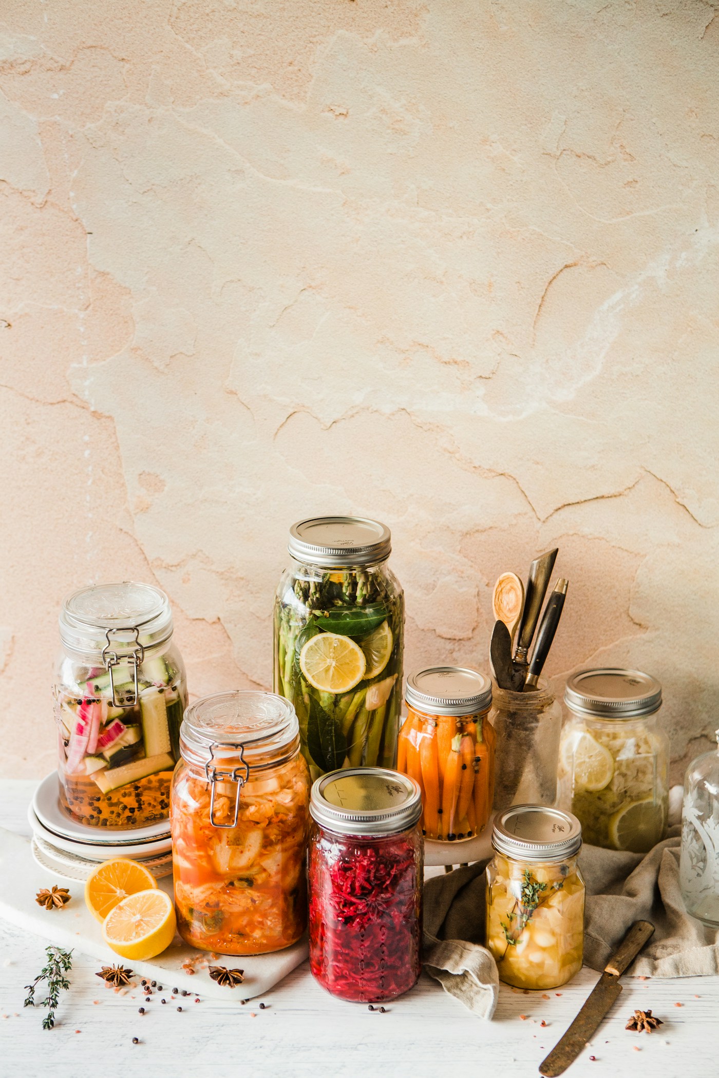 Jars of fermented vegetables, sauerkraut and pickles on a kitchen counter - fibre and fermented food beat a daily probiotic capsule for healthy adults