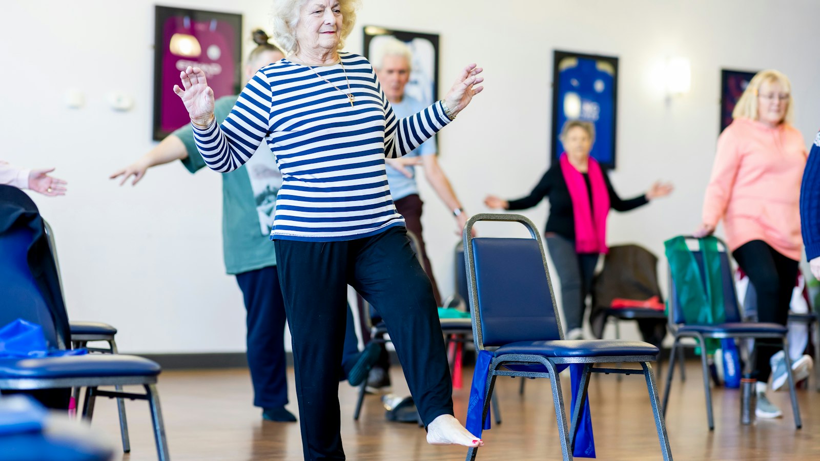 Group of older women doing a balance and movement class, an alternative to vibration plates backed by stronger falls evidence