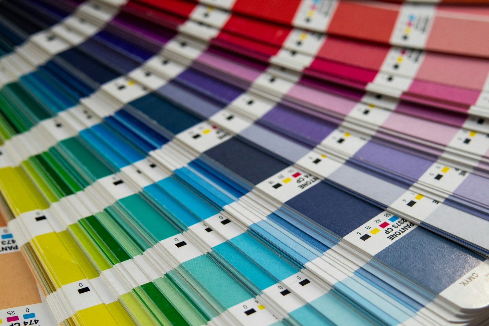 Fanned colour swatch book showing greens, blues and pinks