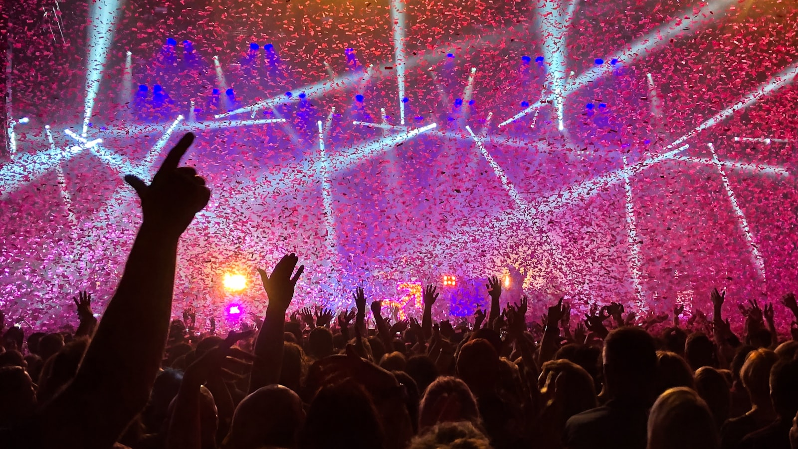 Fans with hands raised at a stadium gig