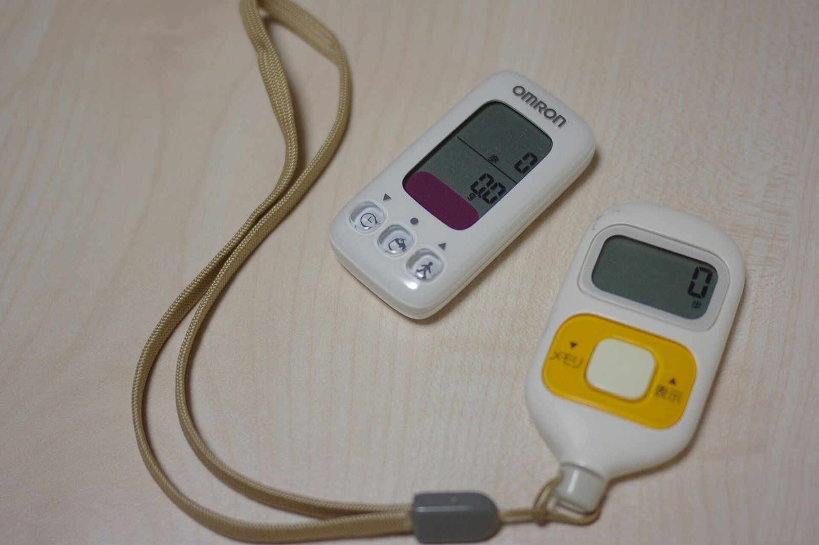 Two Omron clip-on pedometers, the descendants of the 1965 Manpo-kei that invented the 10,000 steps target