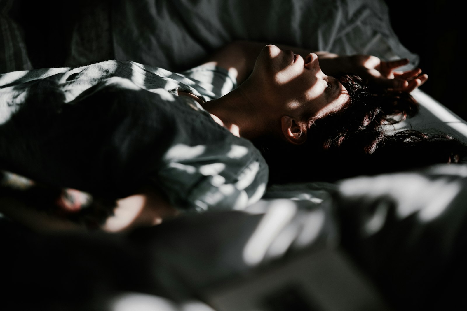 A person asleep in bed - sleeping over seven hours a night cuts cold risk more than any supplement