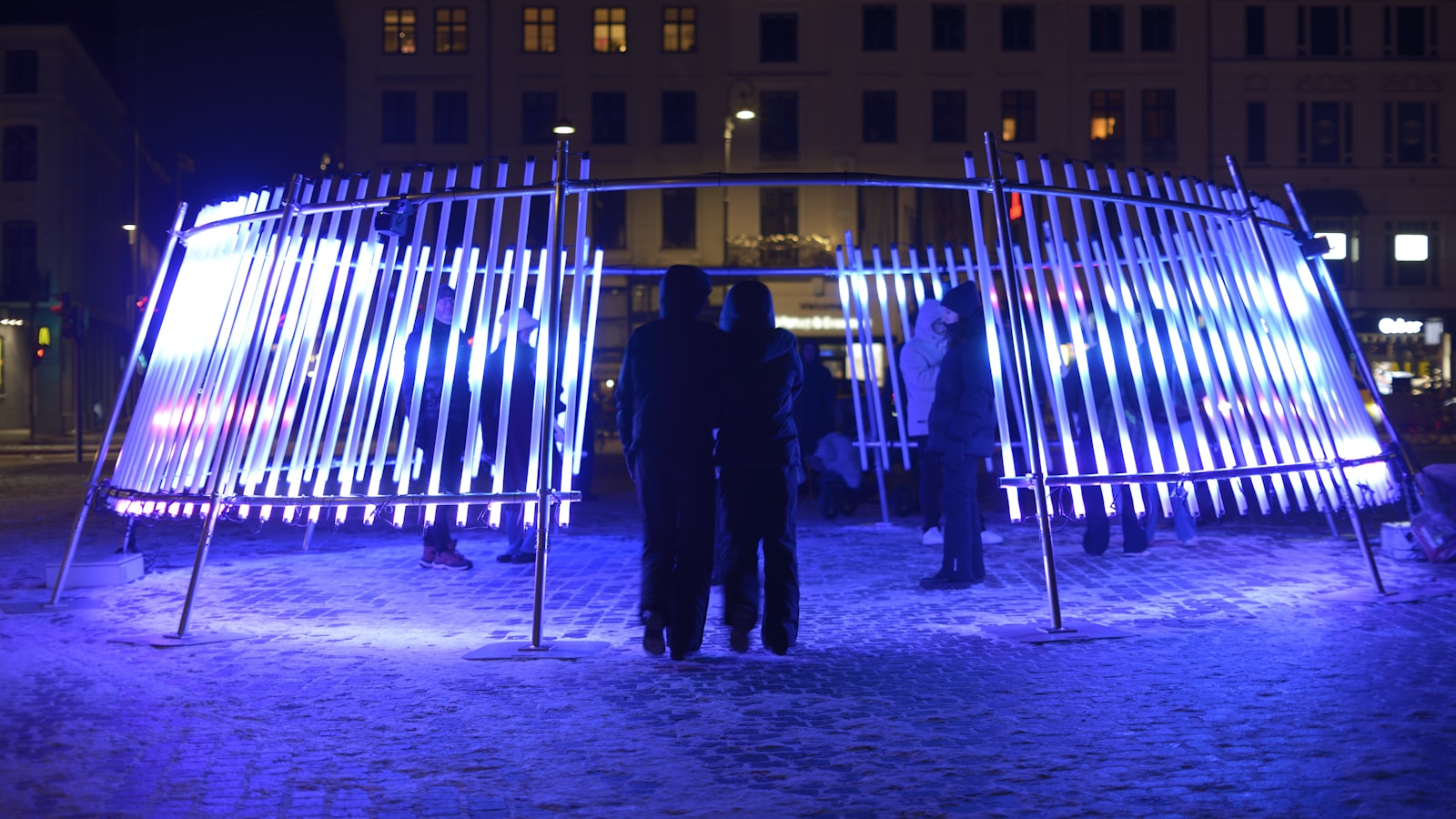 Crowd gathered around a glowing light installation at night, the kind of free after-dark work London Design Festival 2026 brings to St Paul's
